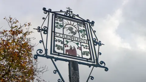 Getty Images A metal village sign which says "Goudhurst" in the middle.